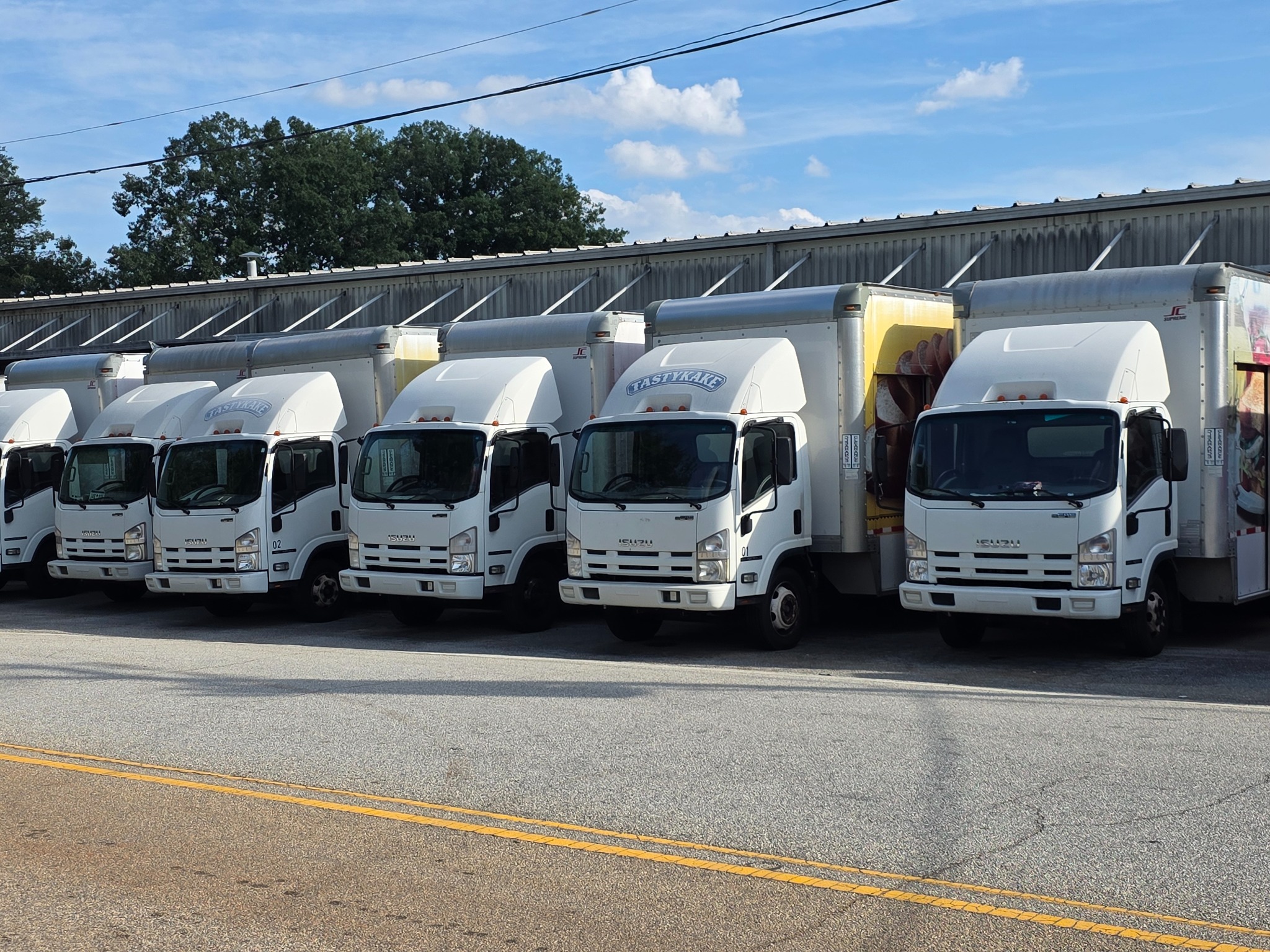 Delivery trucks parked side by side outside the Greenville warehouse